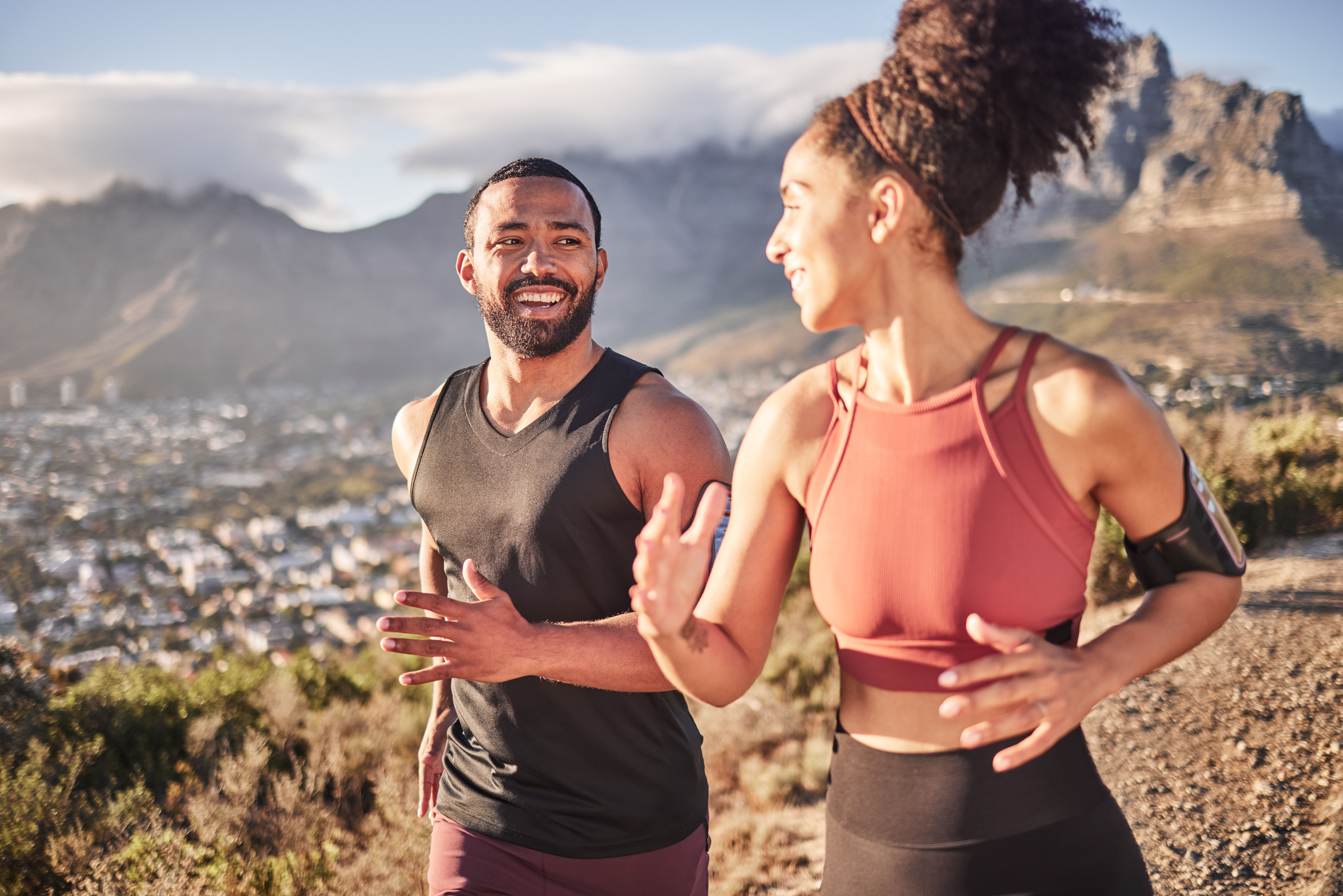 young black couple running on a trail